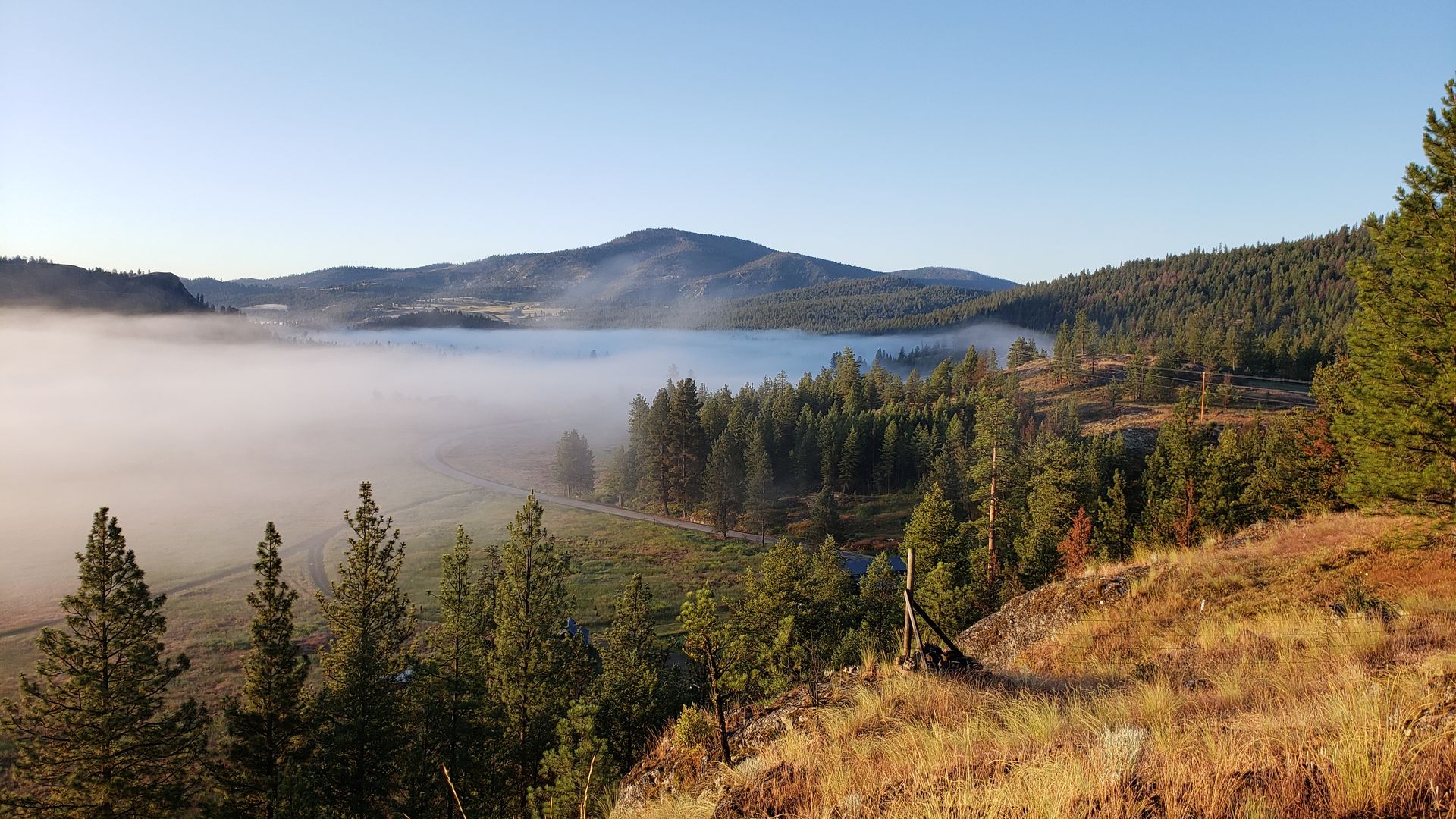 Morning fog lifting over Aeneas Valley, the rural landscape where residents rely on Tonasket for services